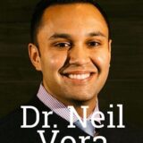 A smiling man with short dark hair, wearing a black sweater and a collared shirt. The text "Dr. Neil Vora" is prominently displayed below his image.
