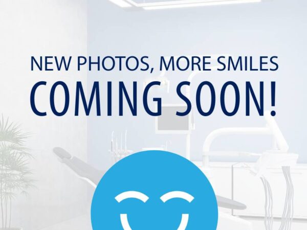 A bright dental office waiting area with modern equipment is featured, alongside a cheerful blue smiley face icon. The text "NEW PHOTOS, MORE SMILES COMING SOON!" suggests an upcoming update or announcement related to the practice.